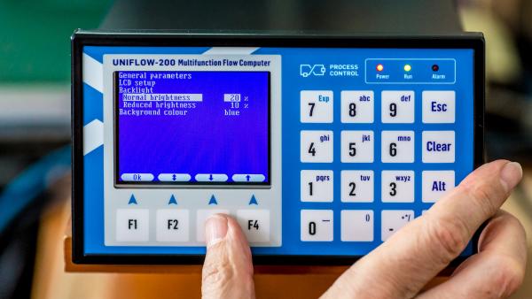 UNIFLOW-200 flow computer front panel with hand pushing buttons